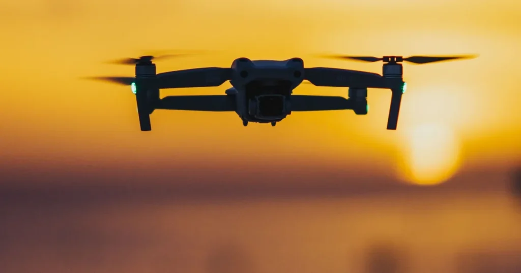 Drone Flying Classes Near Me: Where to Train in Canada (2026) 2 Drone pilot searching for drone flying classes near me flies a folding drone at sunset