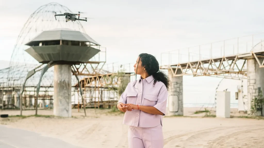 RPAS Operations Manual: 5 Critical Sections to Get Right 2 Crew member keeping visual contact with a drone on a work site, one of the crew roles an RPAS operations manual has to define