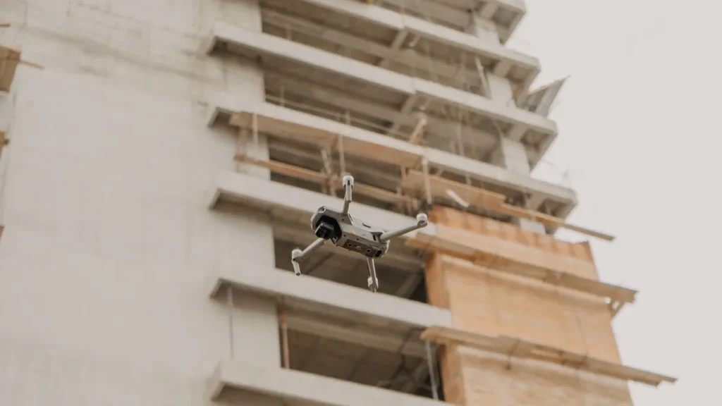 RPAS Operations Manual: 5 Critical Sections to Get Right 4 Folding drone inspecting a building under construction, the kind of work an operator describes in its operations manual