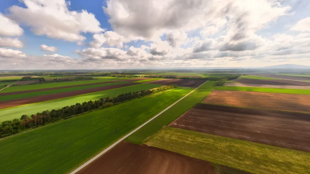 RPOC vs SFOC: 2 Paths, 1 Clear Answer for Your Drone Work 3 Open farmland from the air, the unpopulated and sparsely populated ground where Level 1 Complex BVLOS operates under an RPOC instead of an SFOC