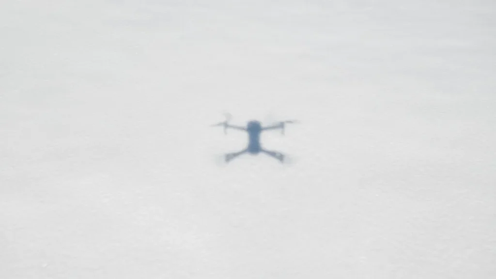 Drone Flying Guide for Canada: 3 Certificates Made Clear 2 Drone small against an overcast sky, close to the limit of visual line of sight